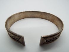 A silver bangle stamped 925.