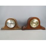 A Napoleons hat mantel clock with carved detailing, Arabic numerals to the dial,