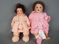 Armand Marseille - a pair of ceramic faced dolls consisting of a n Armand Marseille girl doll with