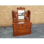 A mahogany dressing table, the mirror back flanked by collumns of twin-drawers,