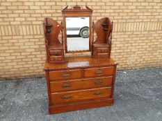 A mahogany dressing table, the mirror back flanked by collumns of twin-drawers,