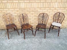 A set of four oak hoop-back dining chairs [4]
