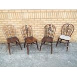 A set of four oak hoop-back dining chairs [4]