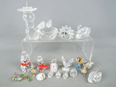 A collection of Swarovski and similar to include swans, candlestick, animals and other.