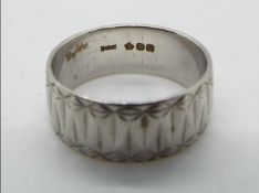 A platinum wedding band, size O, no fineness mark, hallmarked with orb in pentagon, London assay,