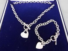 A boxed set of silver necklace and silver bracelet