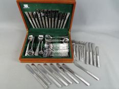 A canteen of Viners stainless steel cutlery with a quantity of similar loose pieces.