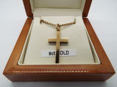 A hallmarked 9ct gold crucifix pendant on chain approximate length 60cm, stamped 375,