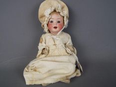 Porzellanfabrik Mengergereuth - a ceramic faced doll with sleeping blue eyes,