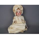 Porzellanfabrik Mengergereuth - a ceramic faced doll with sleeping blue eyes,