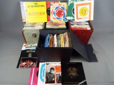 A collection of 45 RPM vinyl records contained in four carry cases to include Queen, Deep Purple,