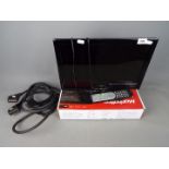 A 16" Alba flatscreen television with built in DVD player and a boxed Freeview HD Recorder.