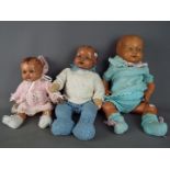 Dolls - a collection of three composition dolls to include a boy baby doll with jointed arms,