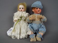 Heubach Koppelsdorf - a set of two ceramic faced dolls to include a boy baby doll with ceramic head,