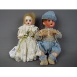 Heubach Koppelsdorf - a set of two ceramic faced dolls to include a boy baby doll with ceramic head,