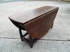 A large oval oak drop-leaf table,