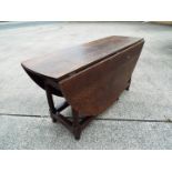 A large oval oak drop-leaf table,