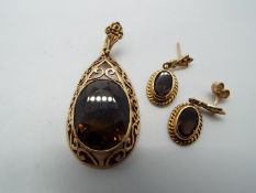 A 9ct gold stone set pendant with matching earrings (one is lacking the butterfly),