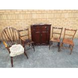 A wall mounted oak corner cabinet and four chairs [5]