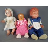 Vintage Dolls - two vintage dressed moulded dolls, one with voice box and a plastic moulded doll,