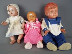 Vintage Dolls - two vintage dressed moulded dolls, one with voice box and a plastic moulded doll,