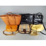 A small collection of lady's handbags including a Burberry 'Nova Check' bag.