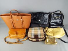 A small collection of lady's handbags including a Burberry 'Nova Check' bag.