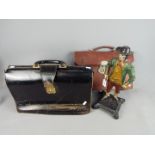 A cast figurine depicting and early New Englander and two vintage satchels / bags.