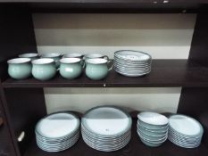 A quantity of Denby dinner and tea wares to include dinner plates, side plates, bowls, cups,