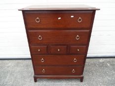 A chest of drawers on four supports measuring approximately 113 cm x 82 cm x 45 cm.