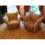 A pair of substantial armchairs finished in red and gold upholstery [2]