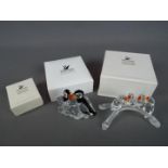 Swarovski - Three boxed Swarovski brooches,