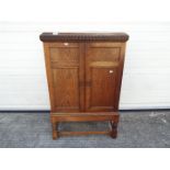 A twin door side cupboard measuring approximately 105 cm x 67 cm x 38 cm Condition Report: A split