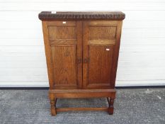 A twin door side cupboard measuring approximately 105 cm x 67 cm x 38 cm Condition Report: A split