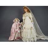 Dolls - two dolls with porcelain heads and hands.