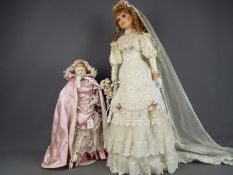 Dolls - two dolls with porcelain heads and hands.