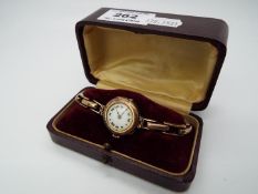 A 9ct gold cased lady's wristwatch (bezel and glass detached),