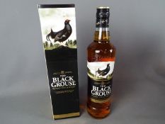 A bottle of Black Grouse 70 cl 40% ABV