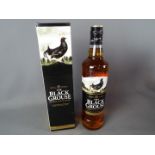 A bottle of Black Grouse 70 cl 40% ABV