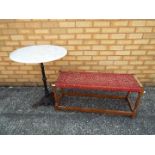 A garden table with cast iron base and marble top,