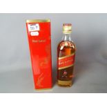 A bottle of Johnnie Walker Red Label 70 cl 40% ABV in presentation tin