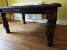 An oak dining table with carved legs,
