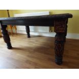 An oak dining table with carved legs,