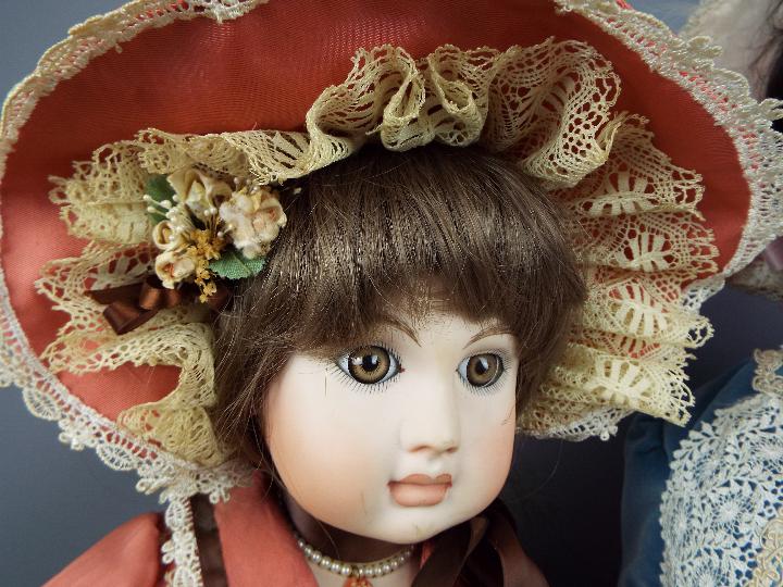 A collection of five beautifully costumed dolls, porcelain heads and hands and fixed glass eyes. - Image 4 of 4