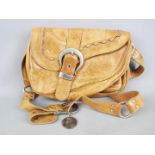 A Christian Dior brown leather 'saddle' bag.