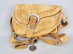 A Christian Dior brown leather 'saddle' bag.