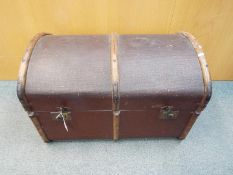 A vintage dome top, wood bound shipping trunk, approximately 50 cm x 77 cm x 50 cm.