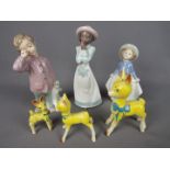 Three Nao figurines, the largest approximately 20.5 cm (h) and three Babycham deer style figurines.