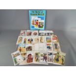 A collection of vintage comic postcards by Donald McGill together with a hardback book entitled The