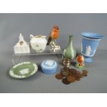 A mixed lot to include Wedgwood Jasperware, Belleek, Goebel, Goss crested ware,